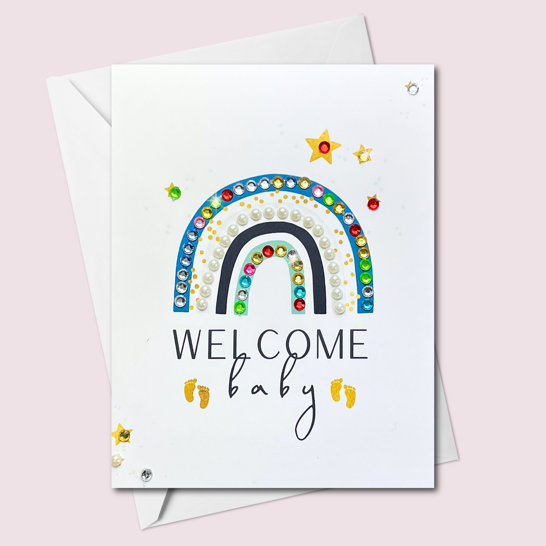 Welcome Baby greeting card with a multicolour rainbow and blue details