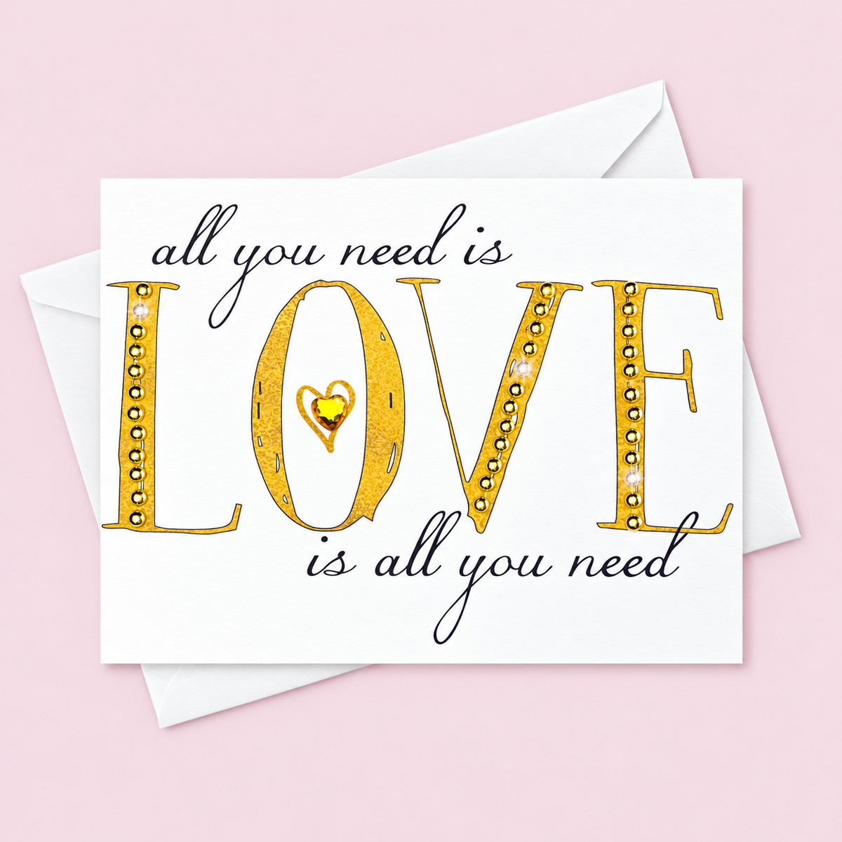 All You Need Is Love  Gold + Crystal greeting card with its original design, shown with a white envelope on a pale pink background
