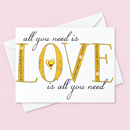 All You Need Is Love  Gold + Crystal greeting card with its original design, shown with a white envelope on a pale pink background