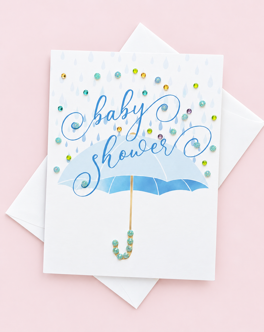 Blue Baby Shower Umbrella Greeting Card greeting card with its original design, shown with a white envelope on a pale pink background