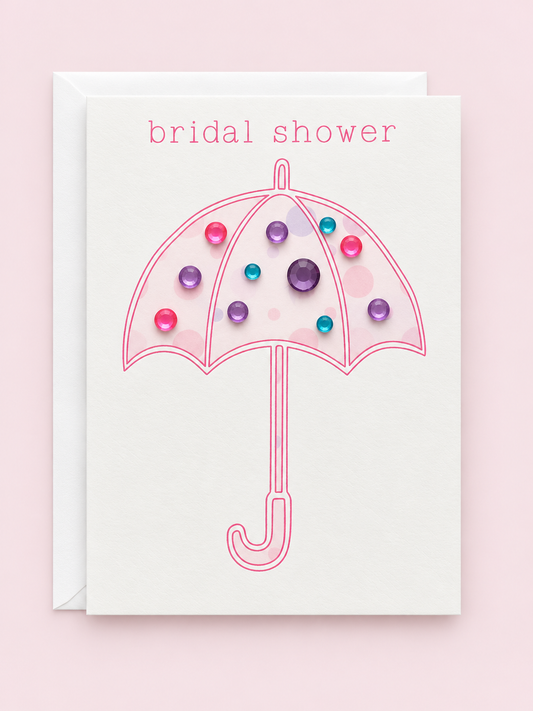 Bridal shower mini with a white envelope on a pale pink background