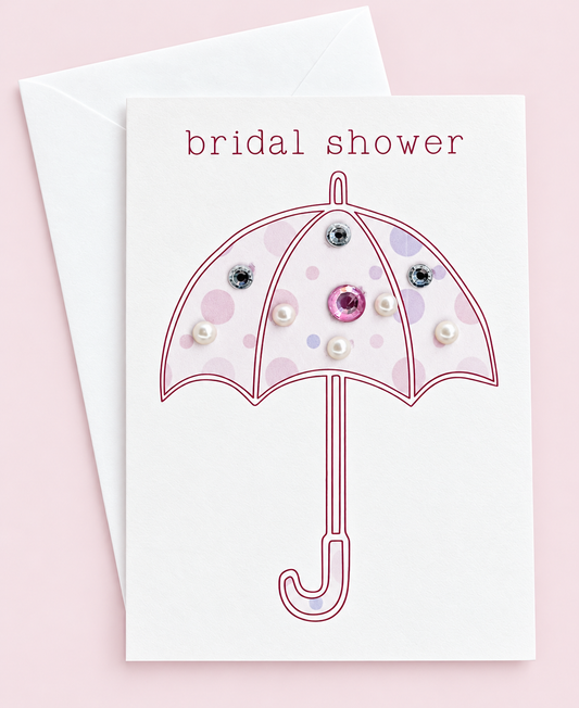 Bridal shower mini with a white envelope on a pale pink background