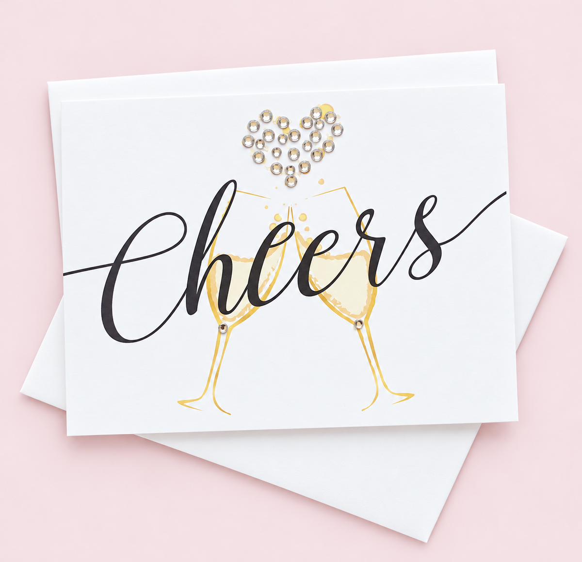 Cheers Champagne Greeting Card greeting card with its original design, shown with a white envelope on a pale pink background