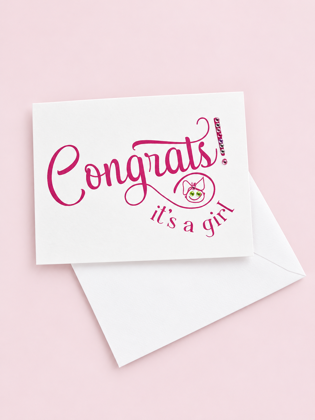 Congrats Its a Girl greeting card with hand-applied sparkling details with a white envelope on pale pink