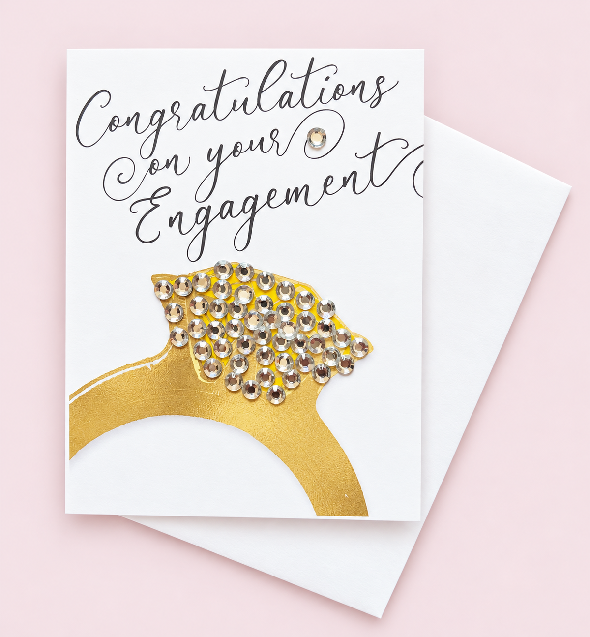 Congratulations On Your Engagement greeting card with its original design, shown with a white envelope on a pale pink background