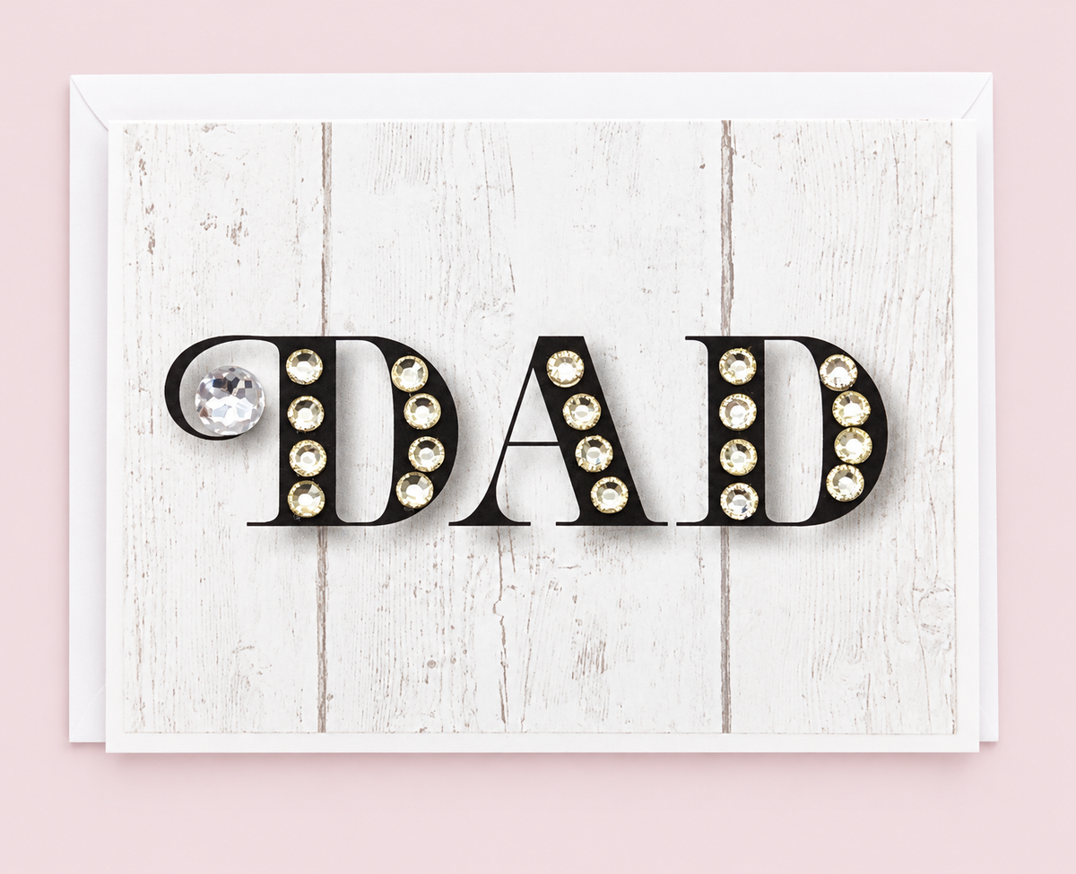 Dad Black with White Sparkle Greeting Card with white envelope on a pale pink background