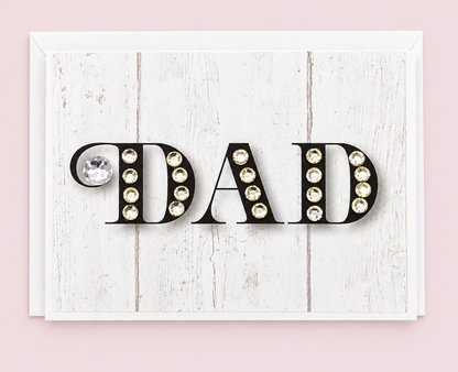 Dad Black with White Sparkle Greeting Card with white envelope on a pale pink background