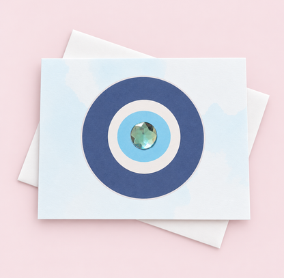 Evil Eye Protection Minimalist greeting card with its original design, shown with a white envelope on a pale pink background