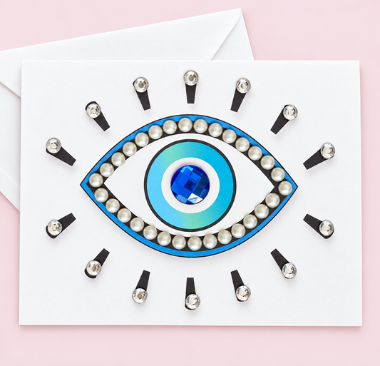 Evil Eye Protection with Pearls greeting card with its original design, shown with a white envelope on a pale pink background