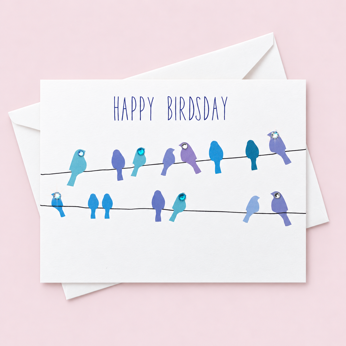Happy Birdsday! Greeting Card with white envelope on a pale pink background
