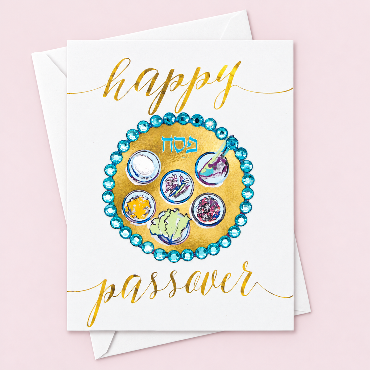 Happy Passover Gold and Blue Sedar Plate Greeting Card with white envelope on a pale pink background