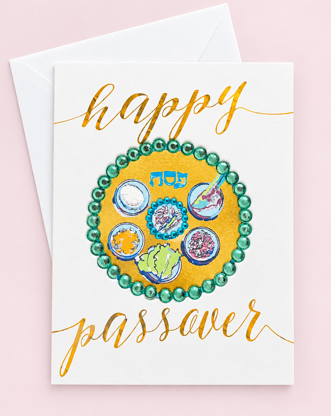 Happy Passover Green Sedar Plate greeting card with its original design, shown with a white envelope on a pale pink background