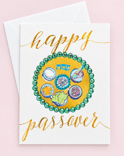 Happy Passover Green Sedar Plate greeting card with its original design, shown with a white envelope on a pale pink background