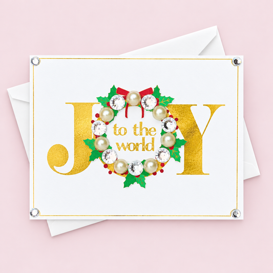 Joy to the World! Wreath Design Greeting Card greeting card with its original design, shown with a white envelope on a pale pink background