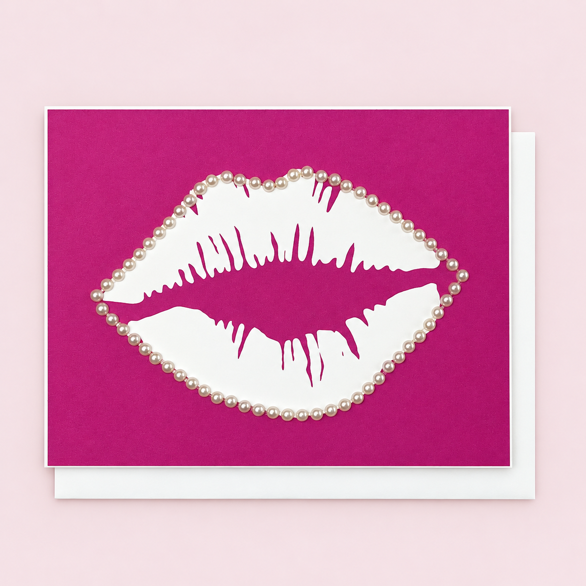 Lips & Pearls with a white envelope on a pale pink background