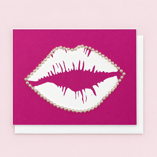 Lips & Pearls with a white envelope on a pale pink background