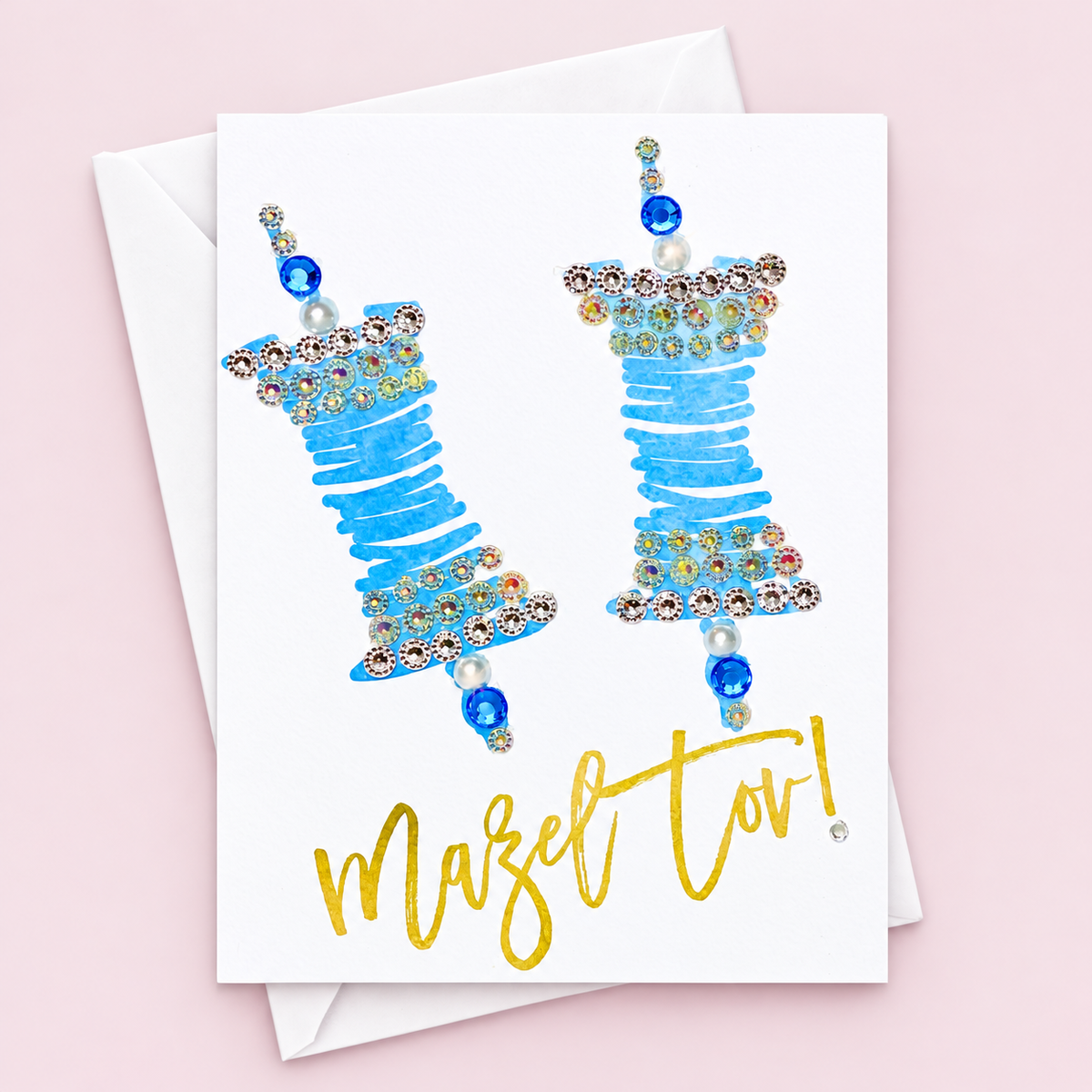 Mazel Tov Bar/Bat Mitzvah - Blue and Gold Torah Scroll greeting card with its original design, shown with a white envelope on a pale pink background