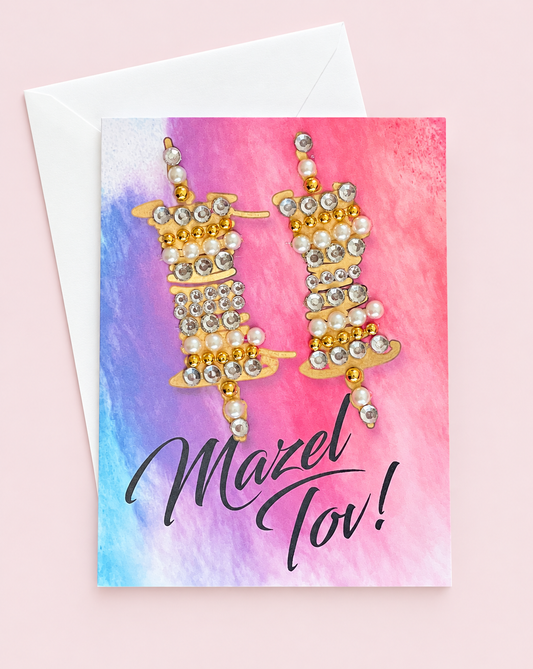 Mazel Tov Bar/Bat Mitzvah Gold Torah Scrolls on Watercolour Background greeting card with its original design, shown with a white envelope on a pale pink background