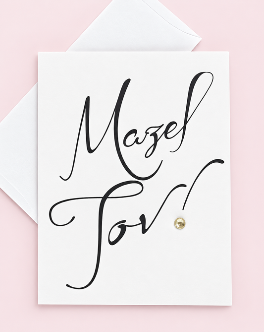 Mazel Tov Black Script greeting card with its original design, shown with a white envelope on a pale pink background