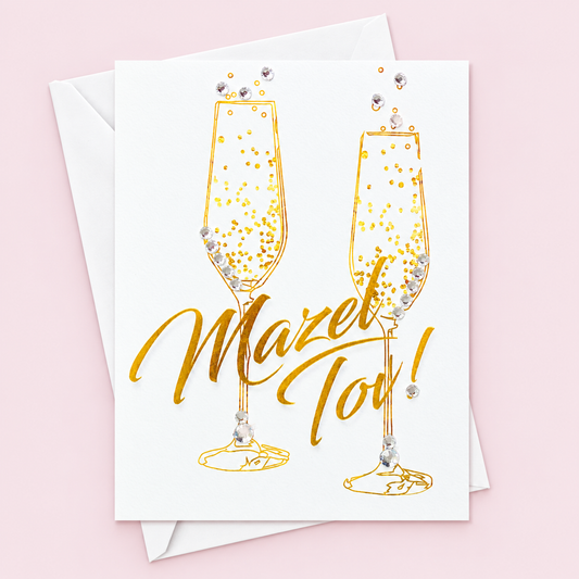 Mazel Tov Champagne Flutes greeting card with its original design, shown with a white envelope on a pale pink background