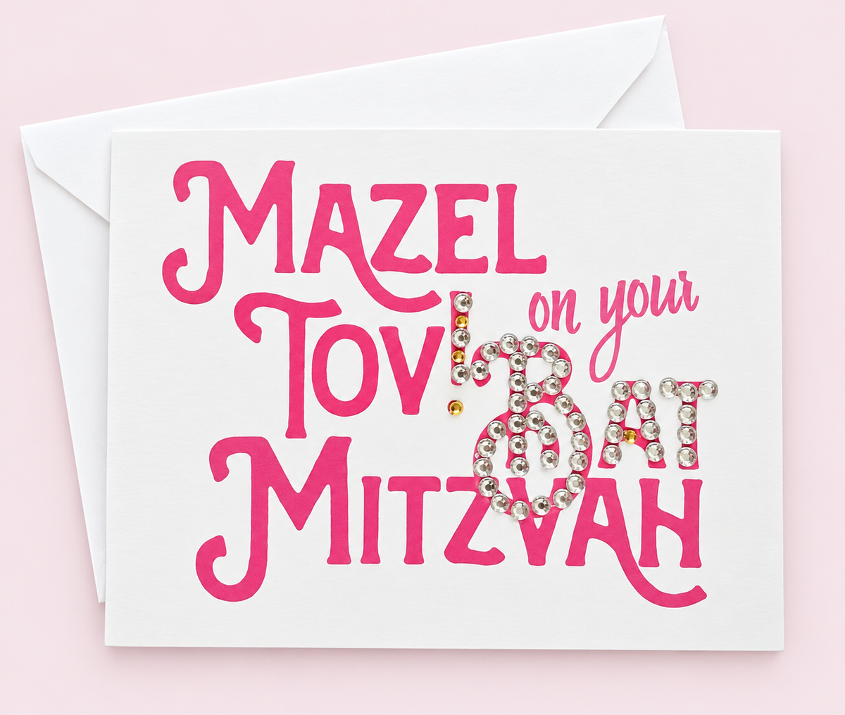 Mazel Tov on your Bat Mitzvah Pink greeting card with its original design, shown with a white envelope on a pale pink background