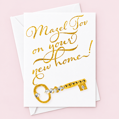 Mazel Tov on your New Home greeting card with its original design, shown with a white envelope on a pale pink background