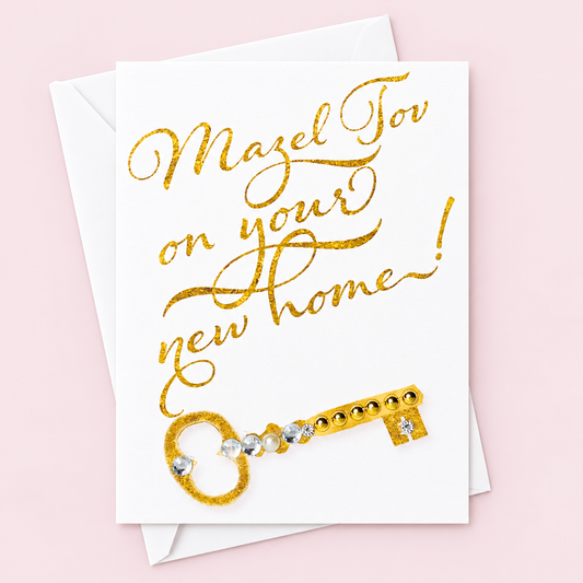 Mazel Tov on your New Home greeting card with its original design, shown with a white envelope on a pale pink background