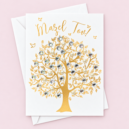Mazel Tov Gold Tree of Life Greeting Card greeting card with its original design, shown with a white envelope on a pale pink background