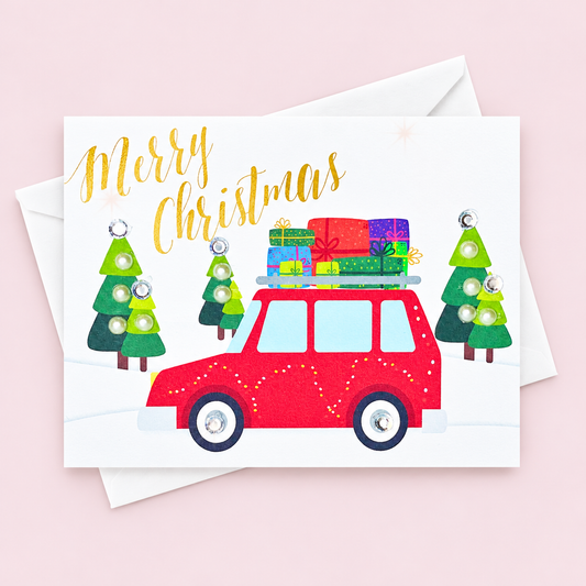 Merry Christmas Red Truck Greeting Card greeting card with its original design, shown with a white envelope on a pale pink background