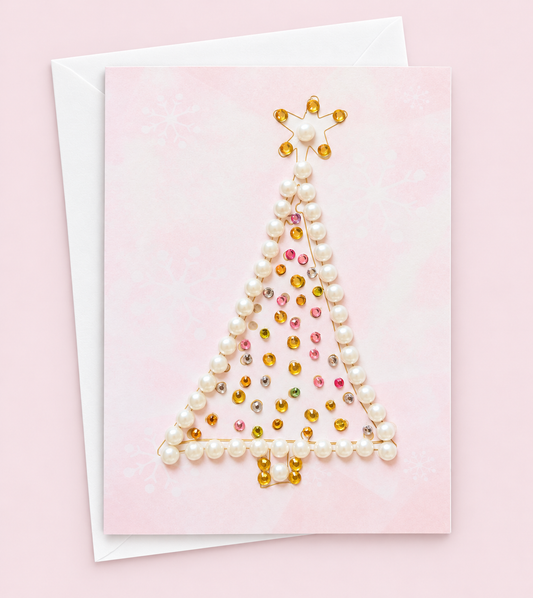 Merry Christmas Tree Greeting Card with star with a white envelope on a pale pink background