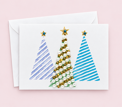 Merry Christmas Trees Greeting Card with a white envelope on a pale pink background