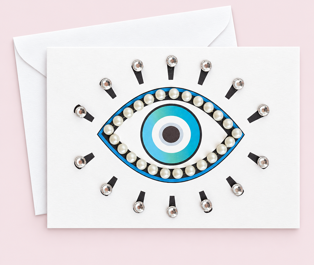 Evil Eye Protection with Pearls - mini size greeting card with its original design, shown with a white envelope on a pale pink background