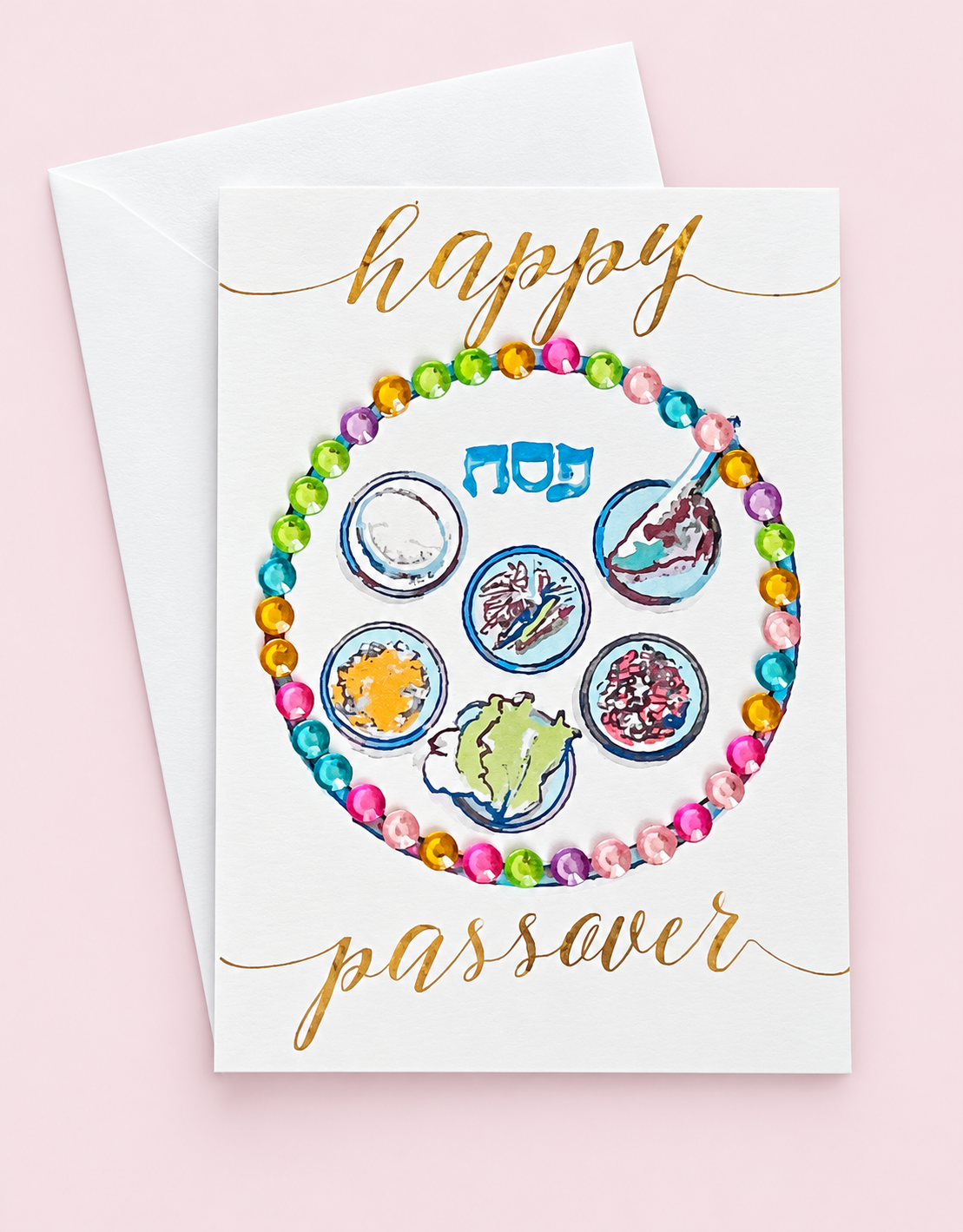 Mini Happy Passover Multicolour Sedar Plate greeting card with its original design, shown with a white envelope on a pale pink background