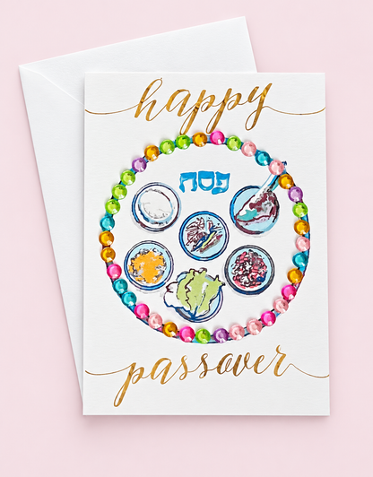 Mini Happy Passover Multicolour Sedar Plate greeting card with its original design, shown with a white envelope on a pale pink background
