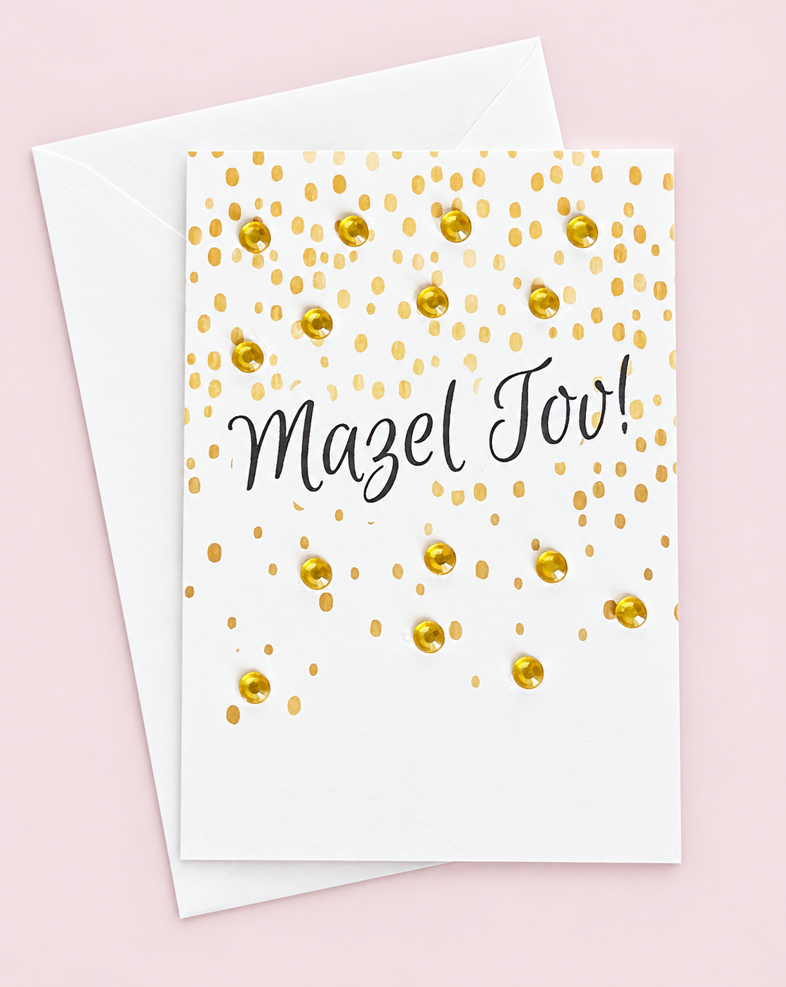 Mini Mazal Tov greeting card with its original design, shown with a white envelope on a pale pink background
