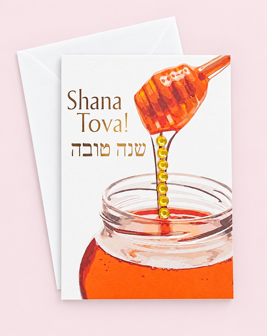 Mini Shana Tova Glass Honey Pot greeting card with its original design, shown with a white envelope on a pale pink background