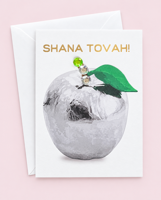 Mini Shana Tova Silver Apple greeting card with its original design, shown with a white envelope on a pale pink background