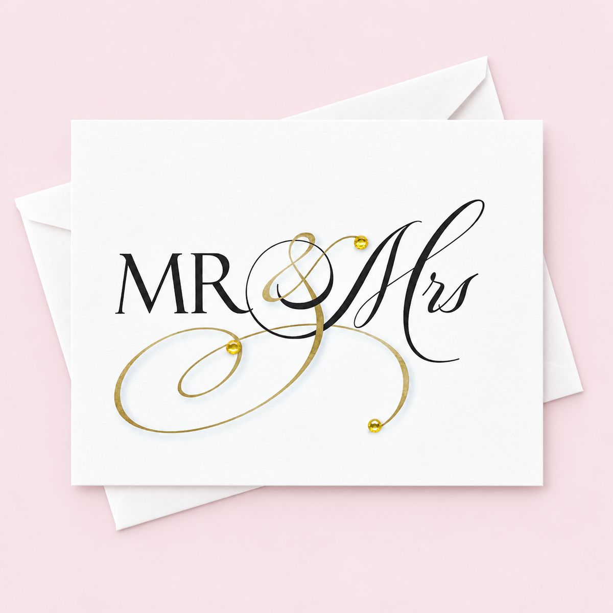Mr & Mrs Wedding Greeting Card – Gold Flourish with Crystal Gem Accents | Blank Inside | Handmade in Canada with white envelope on a pale pink background
