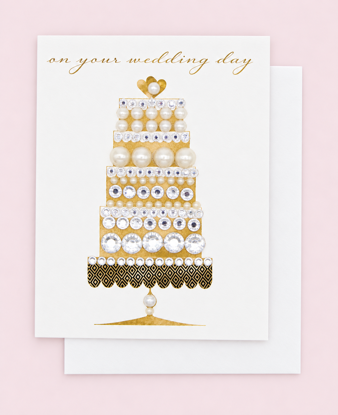 On Your Wedding Day Gold Cake Greeting Card with white envelope on a pale pink background