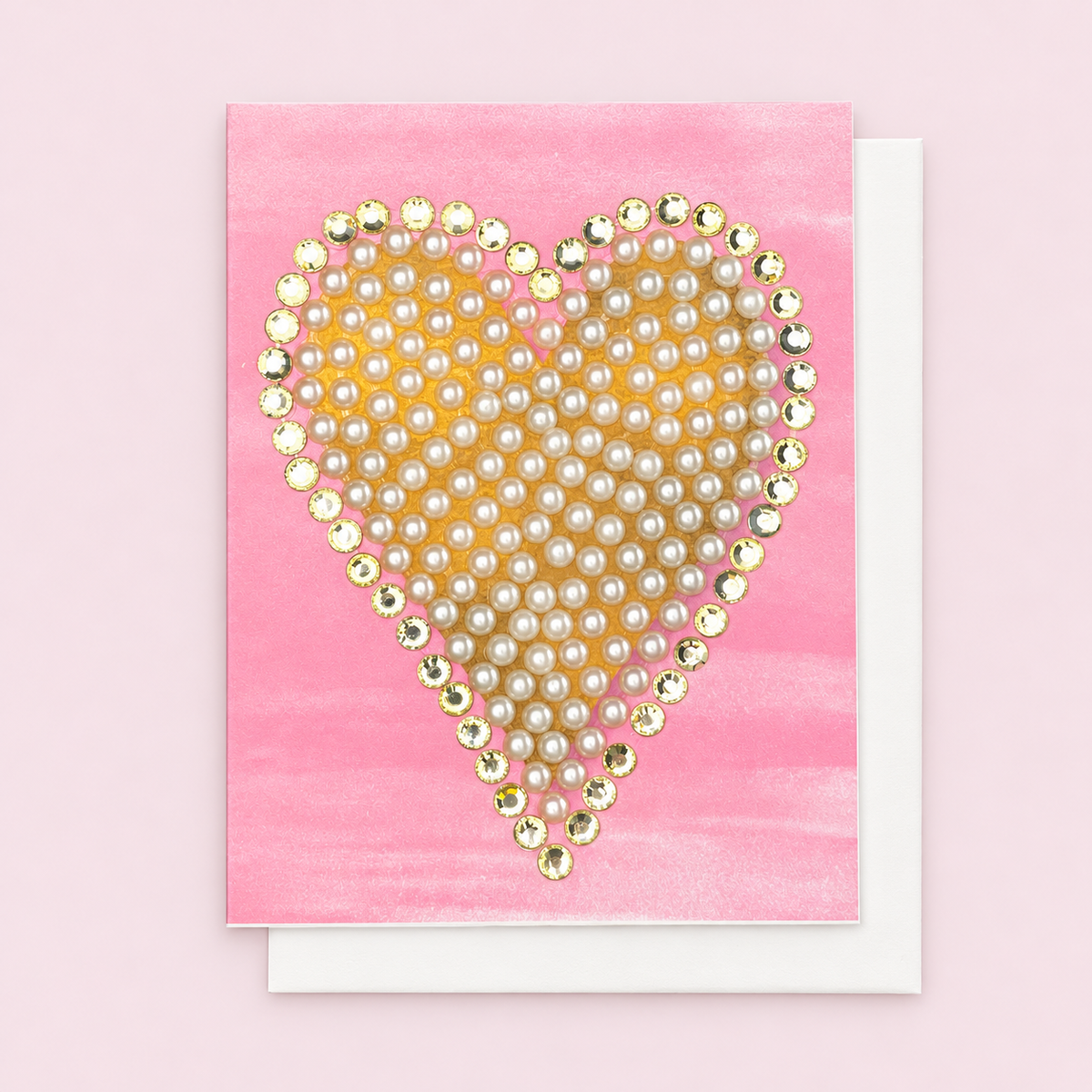 Crystal Edged Pearl Heart with white envelope on a pale pink background
