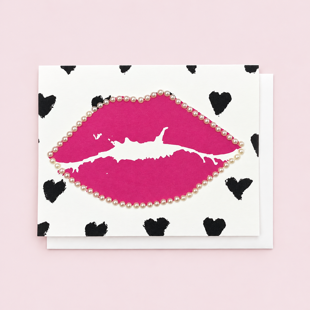 Pink Lips and Black Hearts with white envelope on a pale pink background