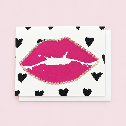 Pink Lips and Black Hearts with white envelope on a pale pink background