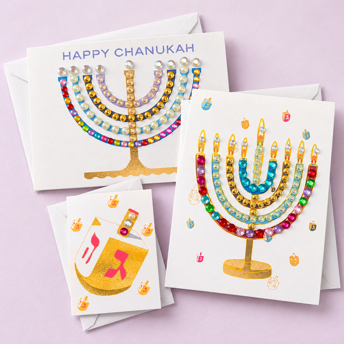 Hand-embellished Chanukah menorah and gold dreidel greeting cards on lavender