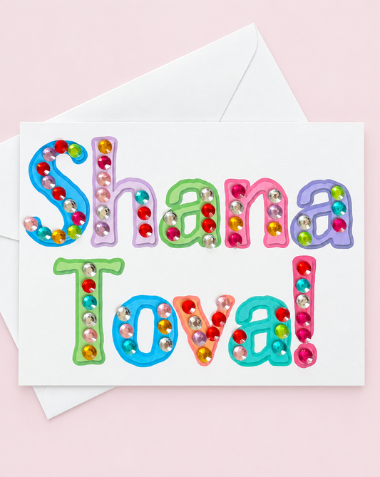 Shana Tova! Colourful Letters Card greeting card with its original design, shown with a white envelope on a pale pink background