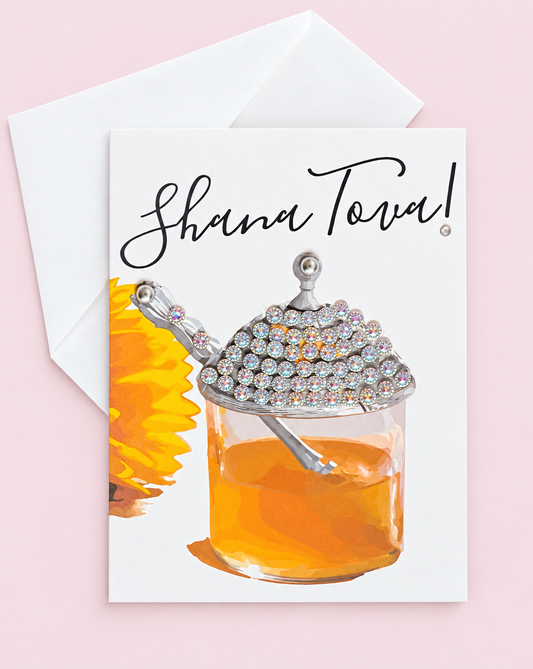 Shana Tova Honey Pot greeting card with its original design, shown with a white envelope on a pale pink background