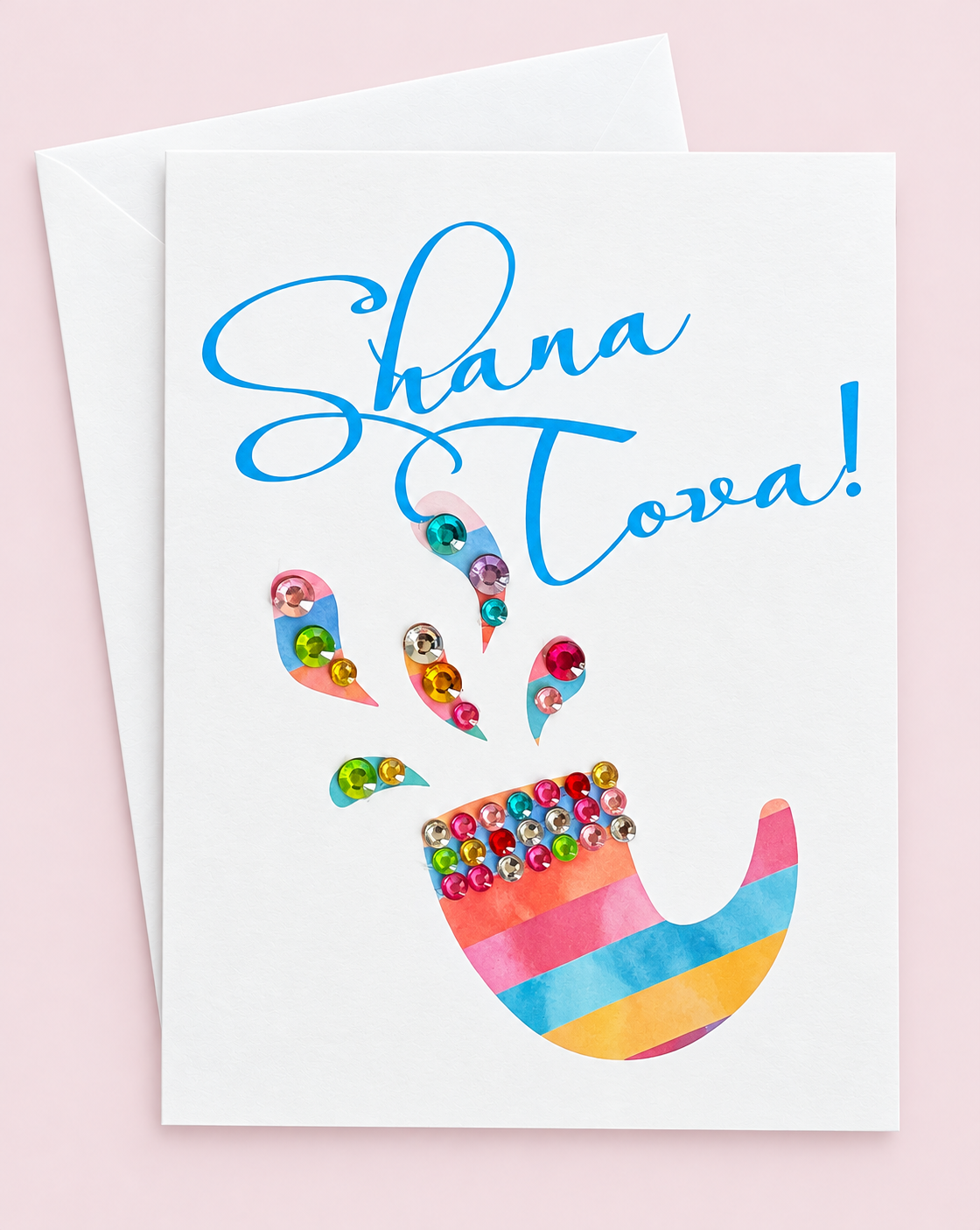 Shana Tova! Rosh Hashanah Stained Glass Shofar greeting card with its original design, shown with a white envelope on a pale pink background