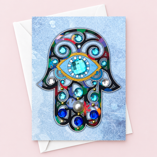 Hamsa Evil Eye Greeting Card – Watercolour Multicolour with Blue Crystal Gems & Pearl | Blank Inside | Handmade in Canada greeting card with its original design, shown with a white envelope on a pale pink background