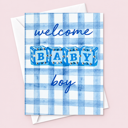 Welcome Baby Boy with a white envelope on a pale pink background