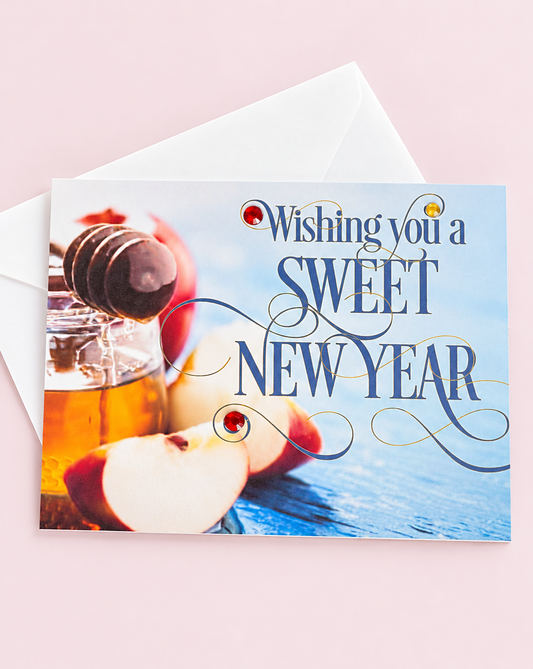 Wishing You a Sweet New Year! Rosh Hashanah Apple & Honey Pot greeting card with its original design, shown with a white envelope on a pale pink background
