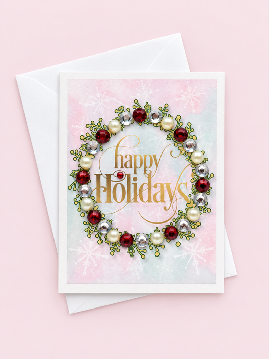 Wreath with ruby stones mini with a white envelope on a pale pink background